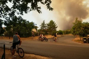 Europe wildfires evacuations response includes water bomber aircraft like this one battling flames from the air