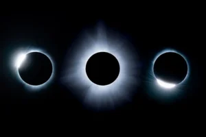 Total solar eclipse showing the sun's white corona around a darkened moon