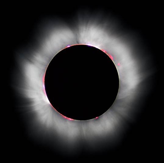 Total solar eclipse corona glowing white around the black disk of the moon
