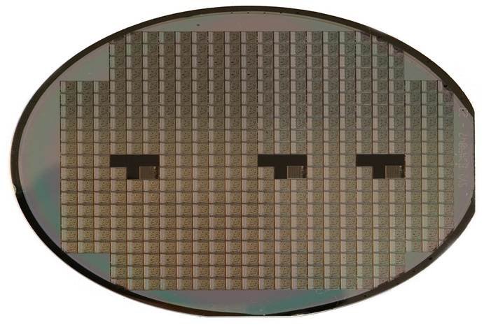 Memory chip investment shown by a silicon wafer patterned with integrated circuits