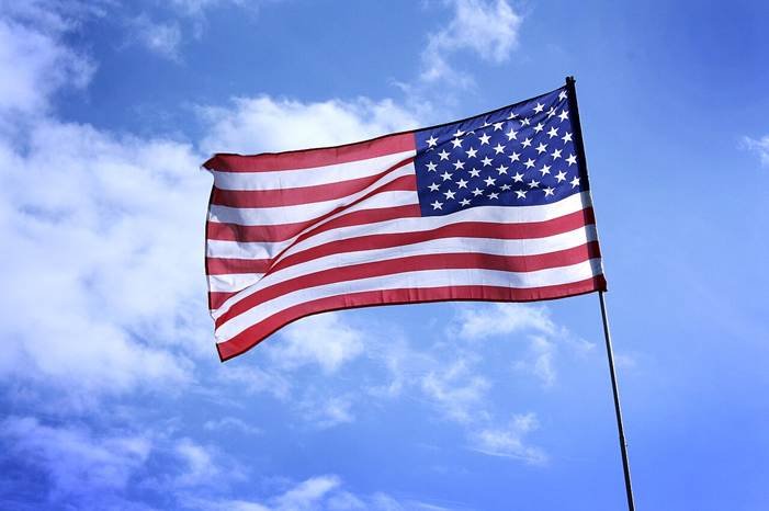 US veteran released home symbolized by an American flag flying against a blue sky