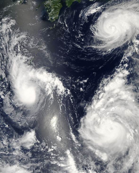 Pacific typhoons shown by a NASA satellite image of multiple typhoons lined up over the western Pacific
