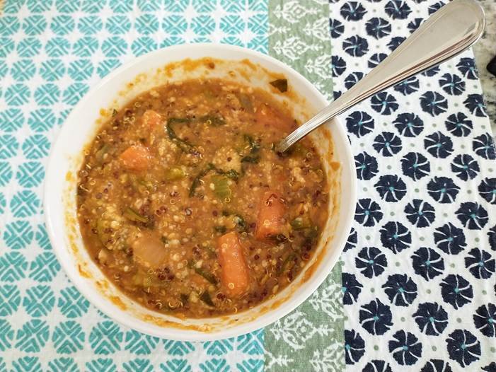 Fibermaxxing favorites like lentils, shown here in a bowl of green and red lentil soup, are cheap high-fiber staples